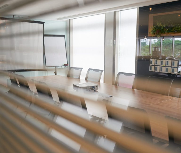 Empty meeting room with big long table